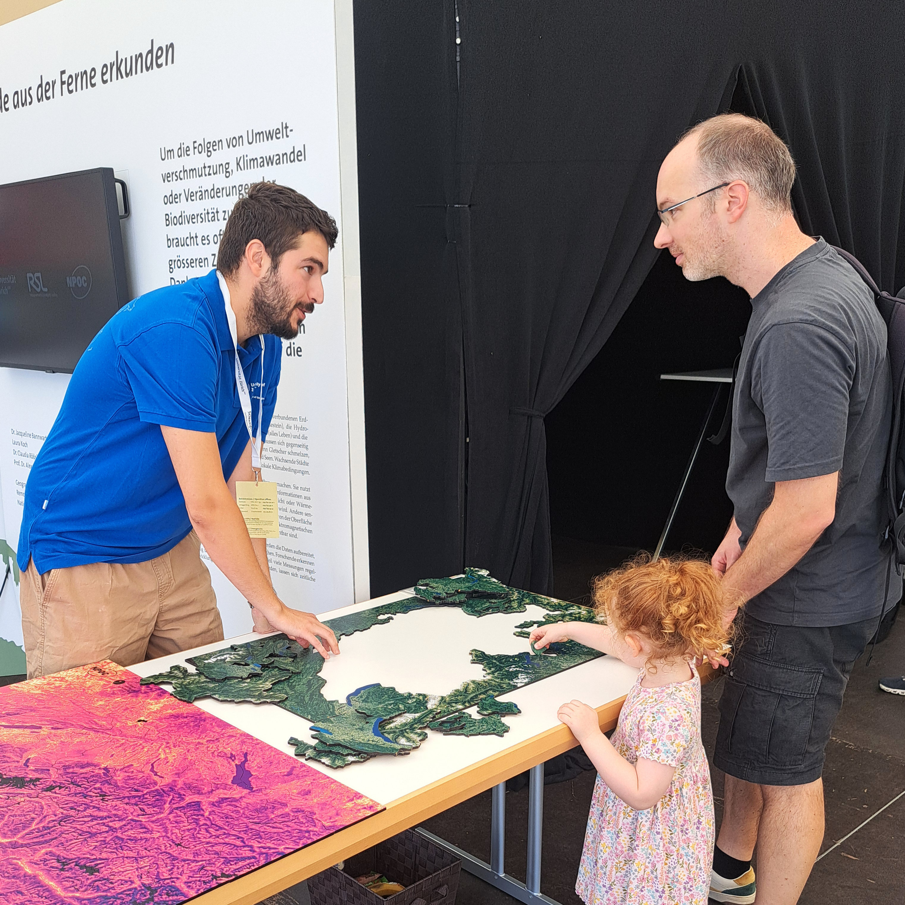 Our scientist Sergio using the Switzerland puzzle to explain how satellites provide information about the Earth's surface.
