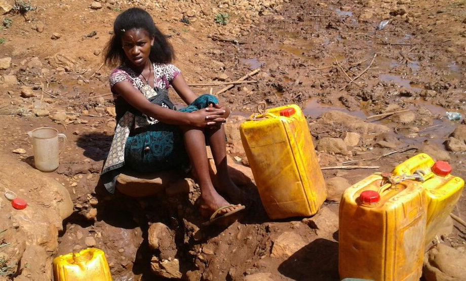 Fetching water near MIDROC Gold Mine